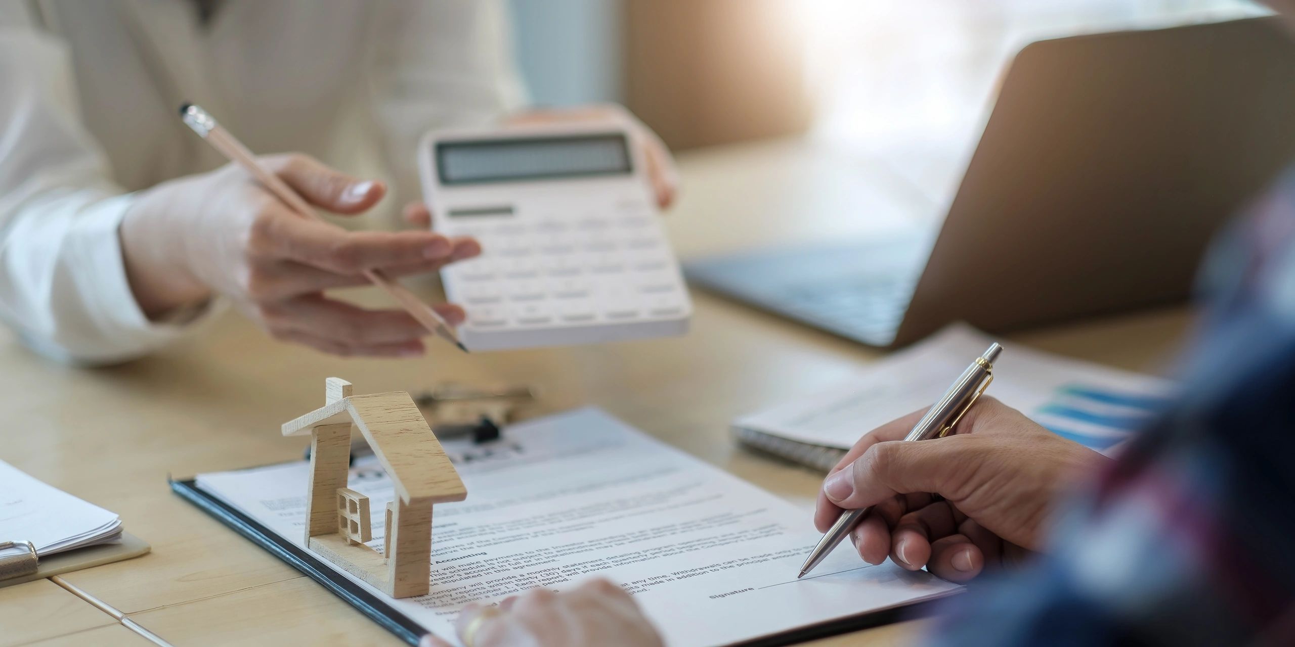 Business people signing a contract related to real estate.