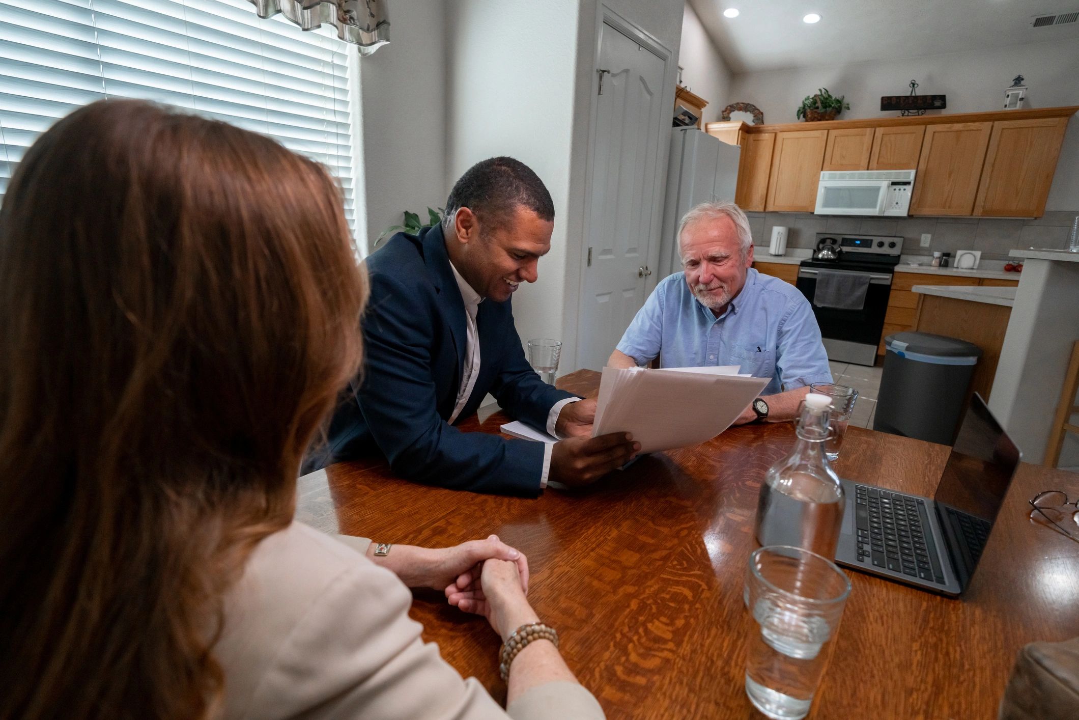 Mortgage advisor meeting with clients at a table