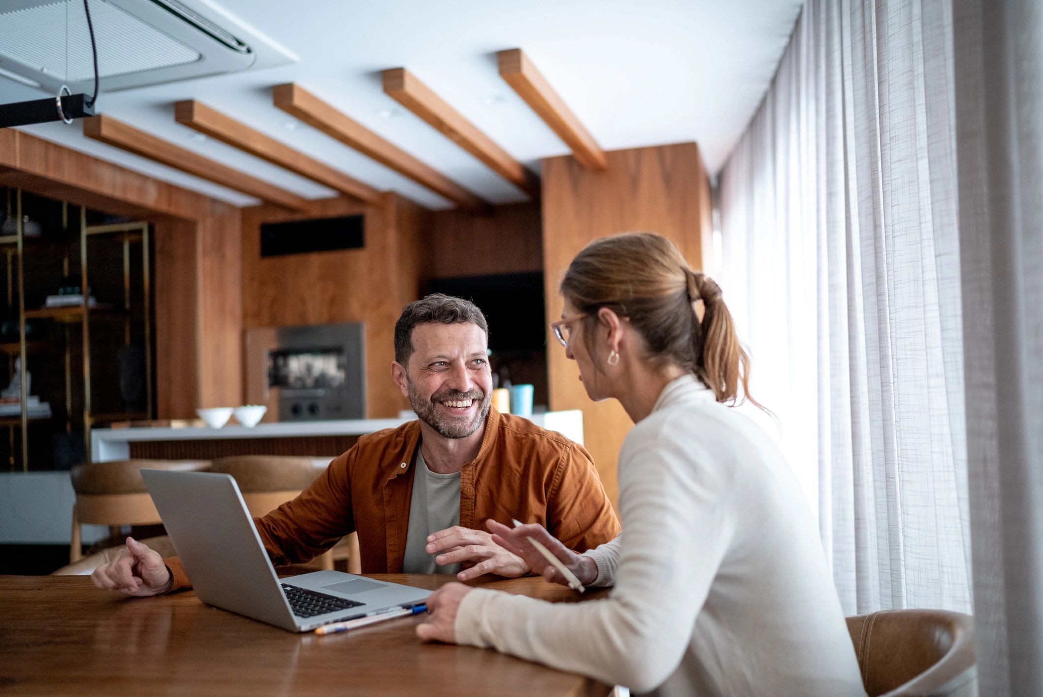 Couple reviewing finances at a kitchen table
