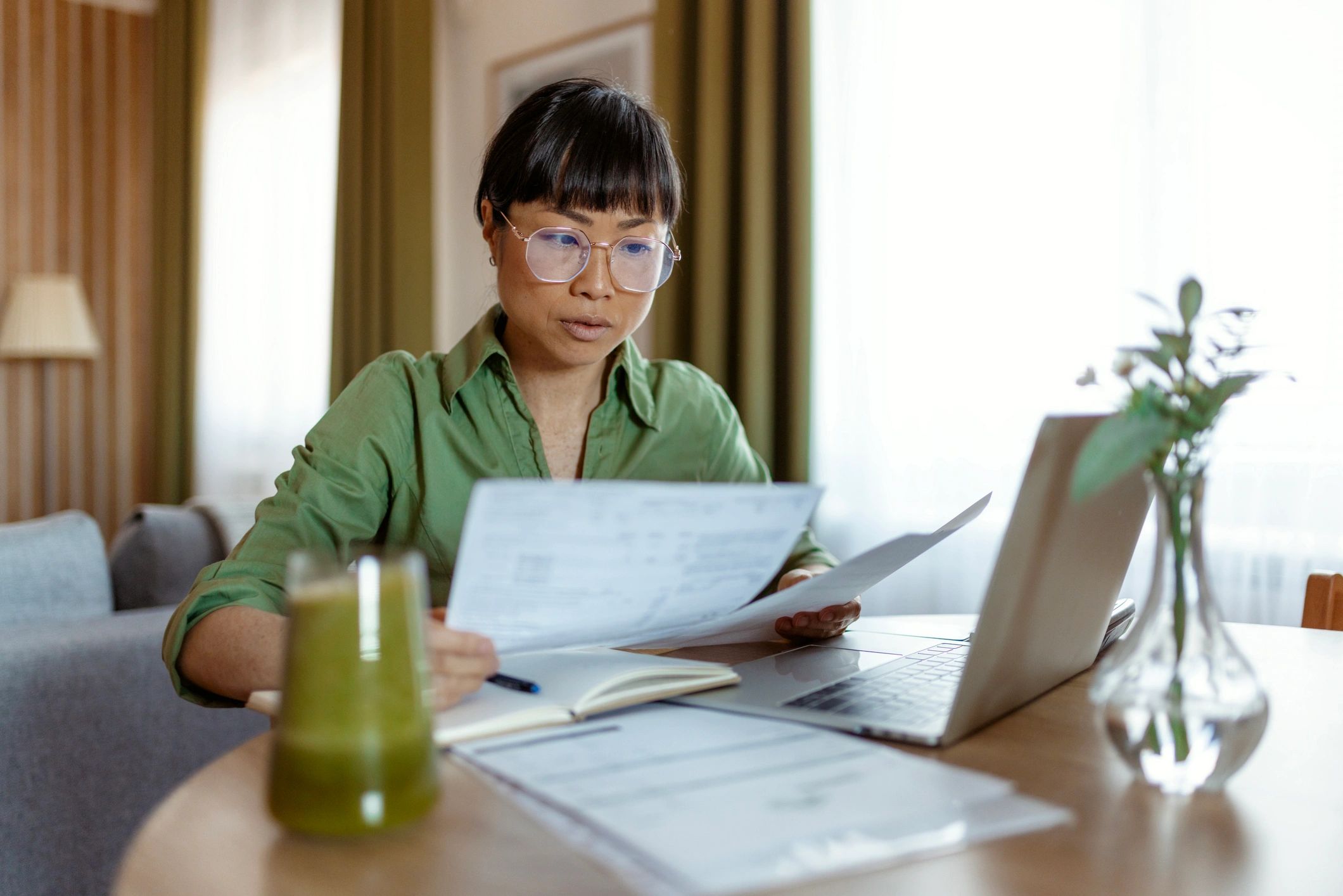 Businesswoman reviewing financial documents in a home office