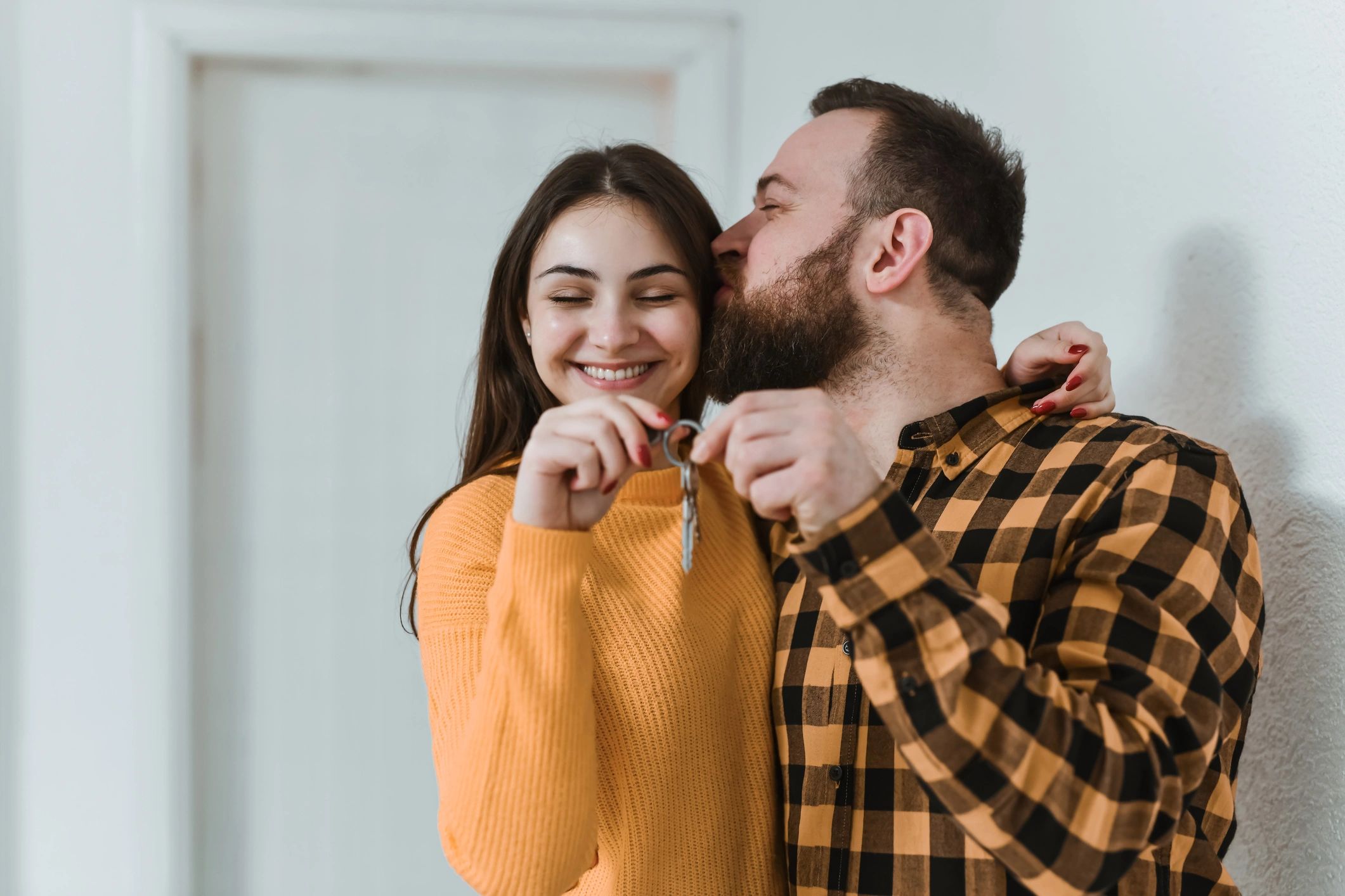 Couple celebrating new home holding a key